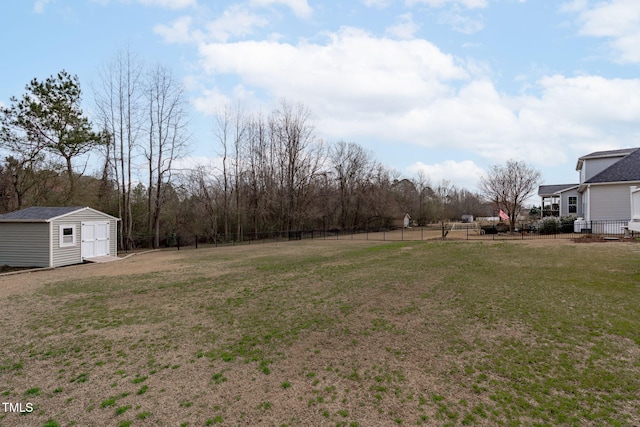 view of yard with a storage unit, fence, and an outdoor structure