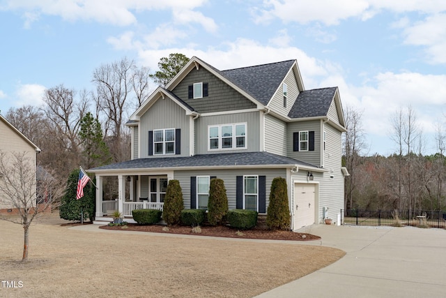 view of front of home with a porch, an attached garage, fence, driveway, and board and batten siding