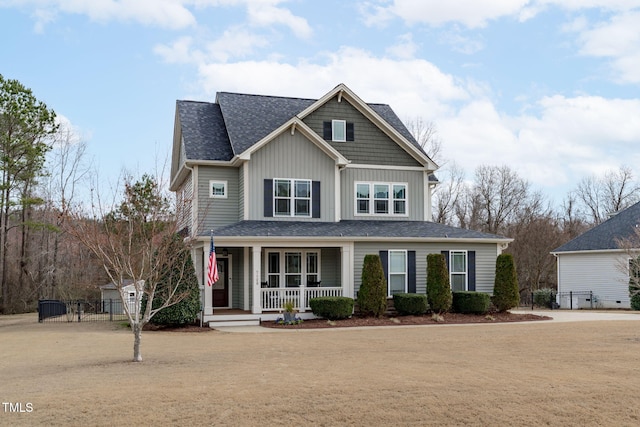 view of front of property featuring fence, a porch, and board and batten siding