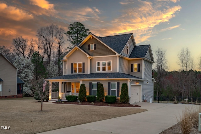 view of front facade featuring an attached garage, fence, covered porch, and driveway