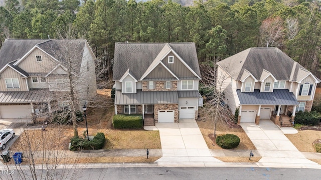 craftsman house featuring a garage, board and batten siding, concrete driveway, and a standing seam roof