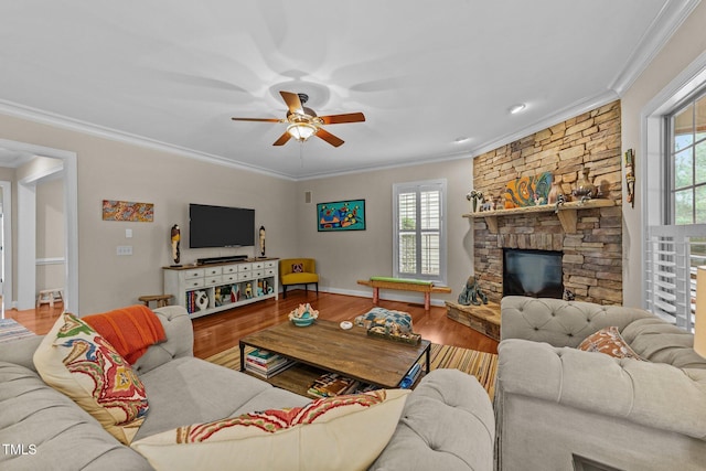 living area featuring plenty of natural light, ornamental molding, and wood finished floors