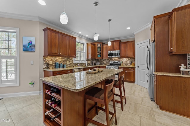 kitchen featuring crown molding, tasteful backsplash, a kitchen island, and stainless steel appliances