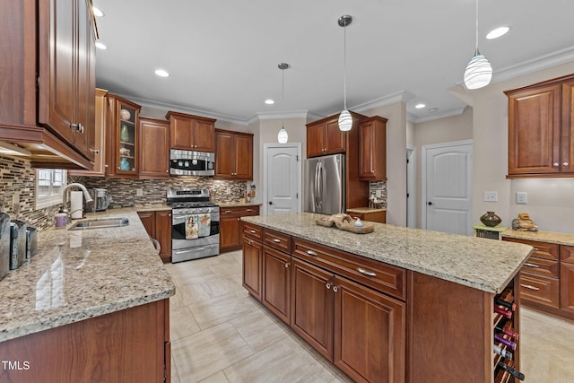 kitchen featuring a center island, light stone countertops, appliances with stainless steel finishes, and a sink