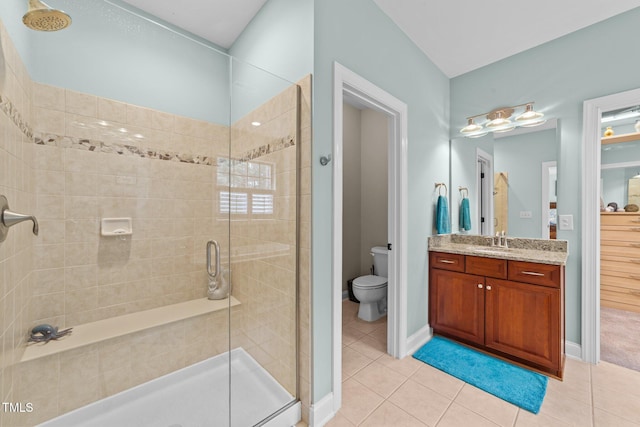 full bath featuring tile patterned floors, vanity, toilet, and a shower stall