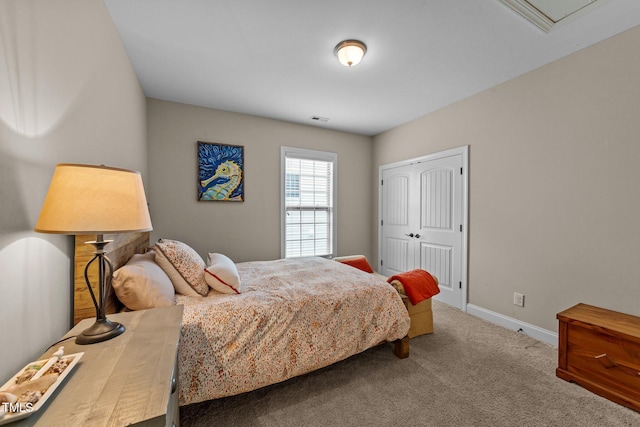 bedroom with baseboards, carpet floors, and a closet