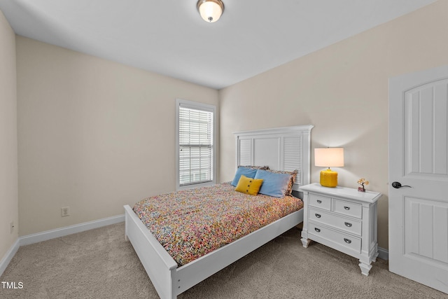 bedroom with light carpet and baseboards