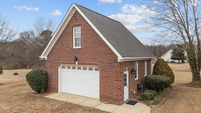 view of side of property featuring a garage and a lawn