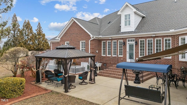 rear view of property featuring a patio area, a gazebo, and outdoor lounge area