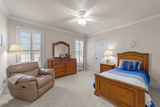 carpeted bedroom featuring ceiling fan and crown molding