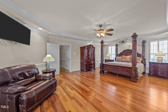 bedroom with light wood-type flooring, ceiling fan, ornamental molding, and multiple windows