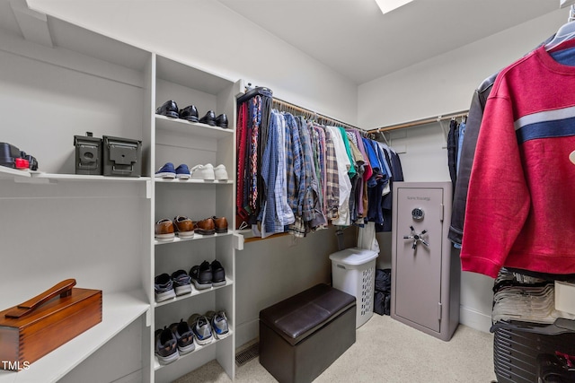 spacious closet featuring light carpet