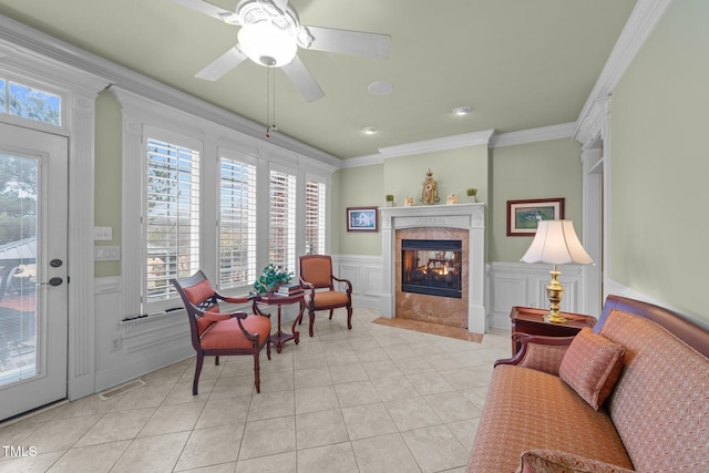 living area with a multi sided fireplace, plenty of natural light, ornamental molding, and light tile patterned flooring