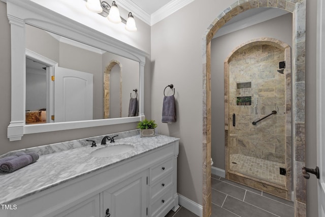 bathroom with tile patterned floors, ornamental molding, a shower with door, and vanity