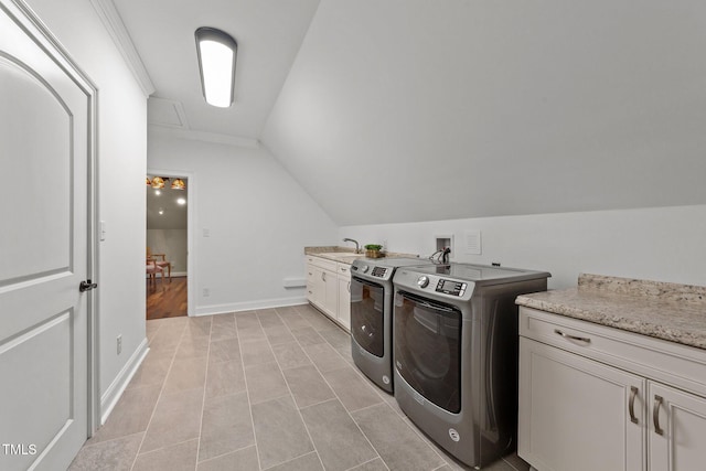 laundry room with light tile patterned floors, cabinets, and separate washer and dryer