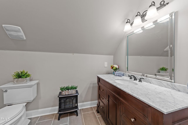 bathroom with tile patterned floors, a wood stove, toilet, vanity, and lofted ceiling