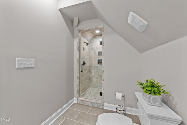 bathroom featuring a shower with door, toilet, tile patterned floors, and lofted ceiling