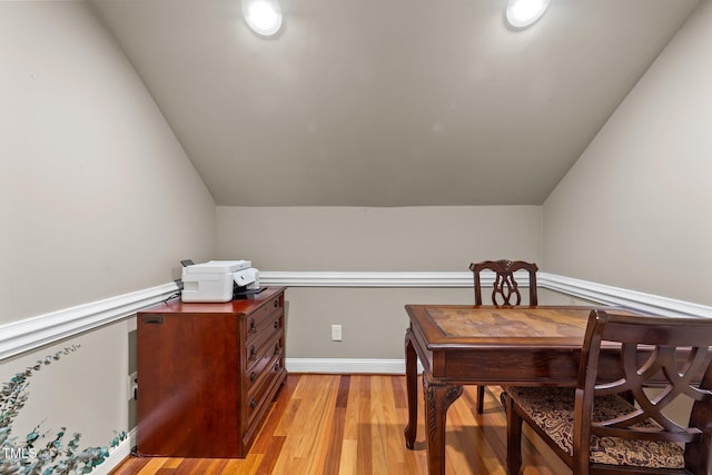 office space with light wood-type flooring and vaulted ceiling