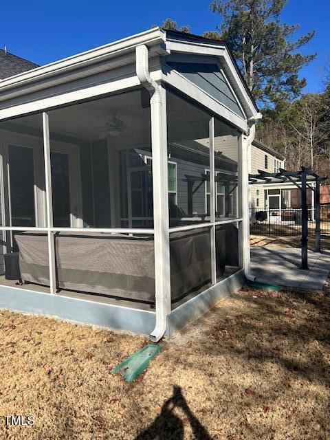 view of property exterior with a sunroom