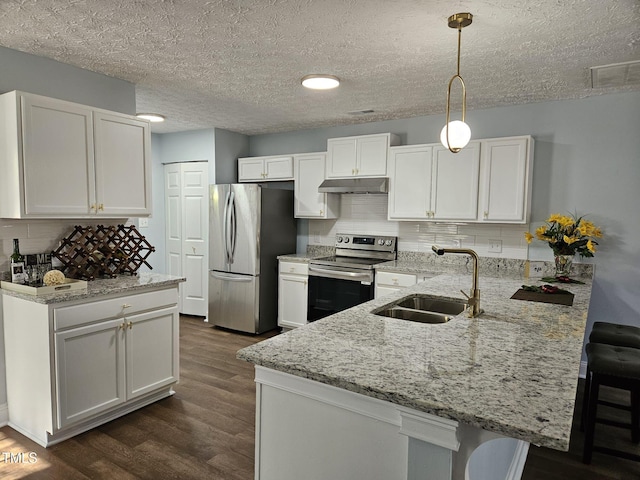 kitchen with sink, white cabinetry, pendant lighting, and stainless steel appliances