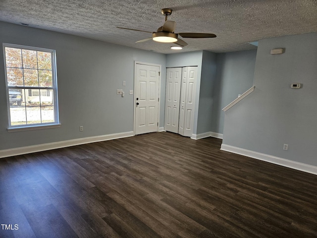 spare room with ceiling fan, dark hardwood / wood-style floors, and a textured ceiling