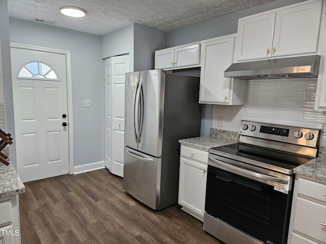 kitchen with white cabinets, stainless steel appliances, a textured ceiling, and tasteful backsplash