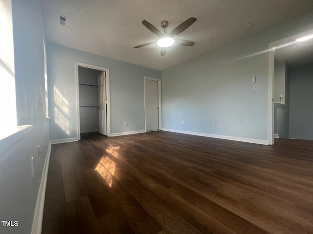 unfurnished bedroom featuring a closet, ceiling fan, and dark hardwood / wood-style floors