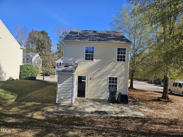 rear view of house with a patio area and a lawn