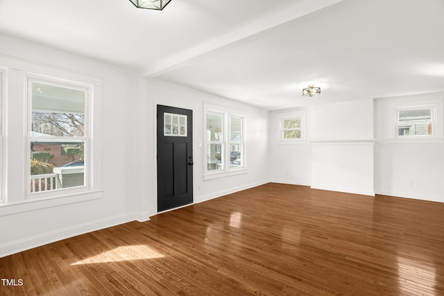 foyer entrance featuring dark wood-type flooring and beam ceiling