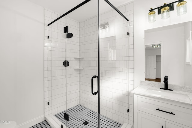 bathroom featuring an enclosed shower and vanity