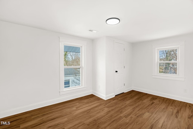 empty room featuring dark hardwood / wood-style flooring