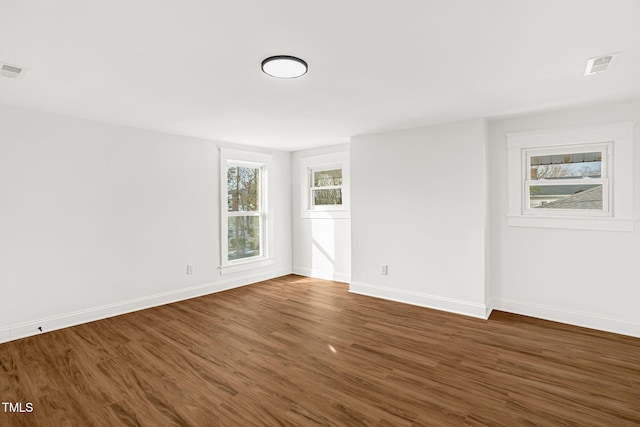 spare room with dark wood-type flooring