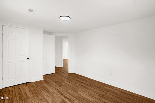 unfurnished bedroom featuring dark hardwood / wood-style floors