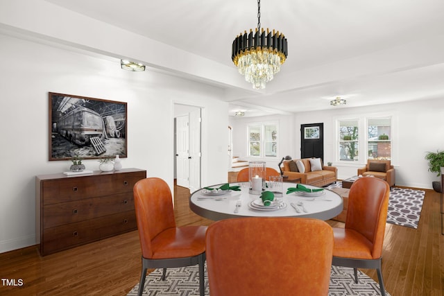 dining space featuring an inviting chandelier and dark hardwood / wood-style floors