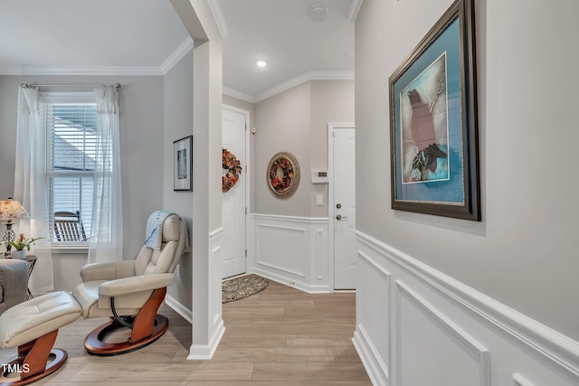 entryway featuring crown molding and light hardwood / wood-style floors