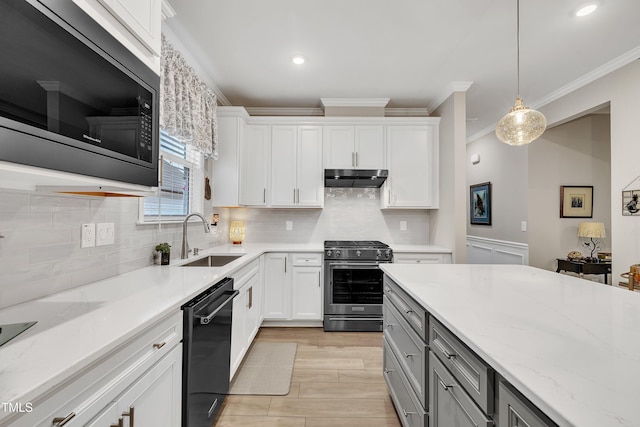 kitchen with built in microwave, white cabinetry, stainless steel range, dishwasher, and pendant lighting