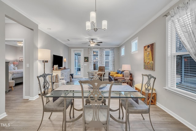 dining space featuring ceiling fan with notable chandelier, crown molding, and light hardwood / wood-style floors