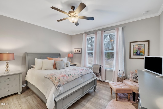 bedroom featuring crown molding, ceiling fan, and light hardwood / wood-style flooring