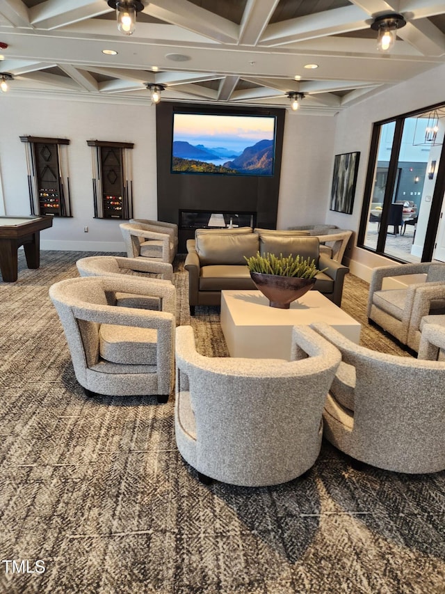 carpeted home theater room featuring coffered ceiling and beamed ceiling