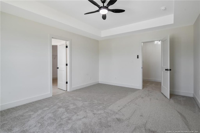 4935 High Branch Ct, Stedman, NC 28391 - unfurnished bedroom featuring a walk in closet, a raised ceiling, and carpet floors