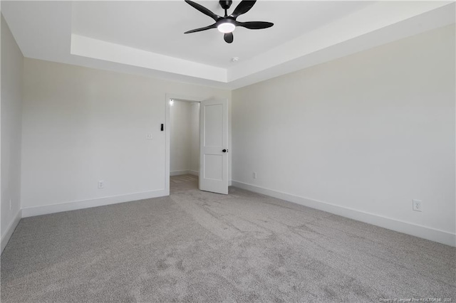4935 High Branch Ct, Stedman, NC 28391 - spare room featuring a tray ceiling, carpet floors, a ceiling fan, and baseboards