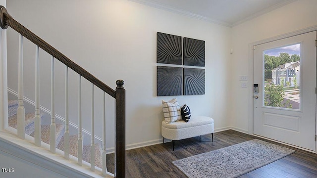 foyer entrance with dark hardwood / wood-style floors and ornamental molding