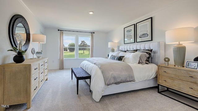 bedroom with crown molding and light carpet