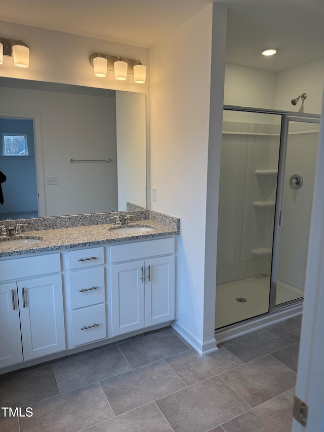 bathroom with a shower with door and vanity