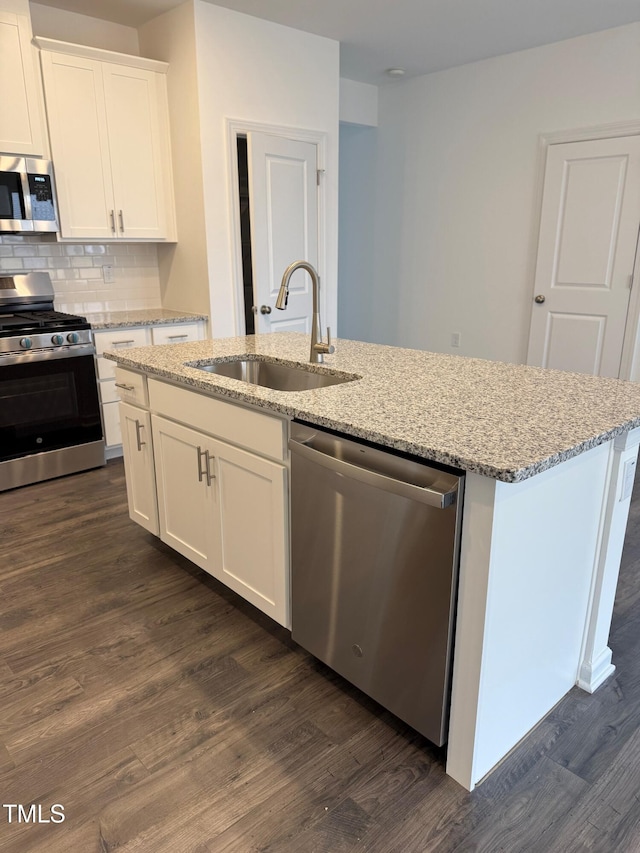 kitchen featuring white cabinets, stainless steel appliances, dark wood-type flooring, and sink