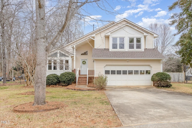 view of front of property featuring a garage and a front lawn