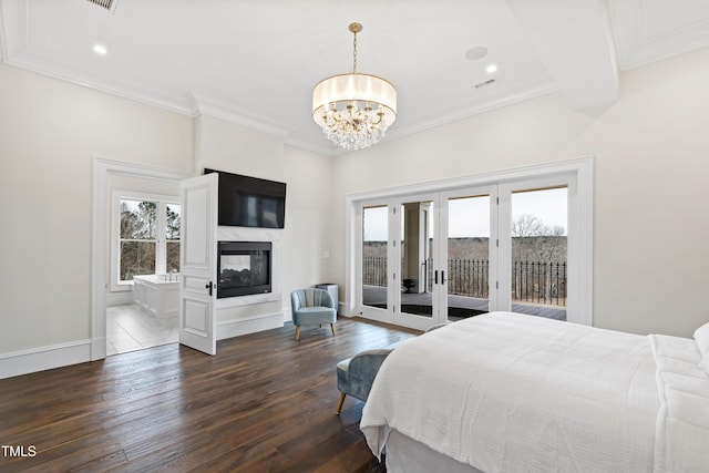 bedroom featuring a multi sided fireplace, dark hardwood / wood-style flooring, access to outside, french doors, and a chandelier