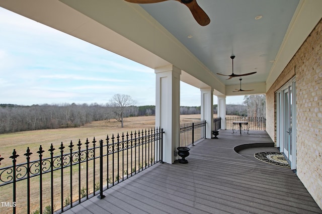 wooden terrace with ceiling fan and a rural view