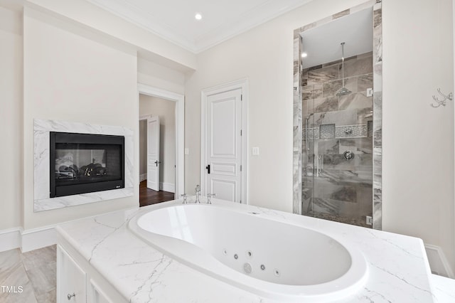 bathroom featuring a high end fireplace, ornamental molding, and separate shower and tub