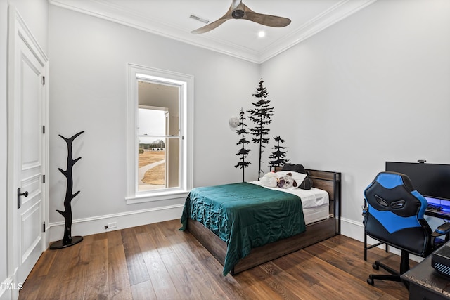 bedroom with dark wood-type flooring, ceiling fan, and ornamental molding